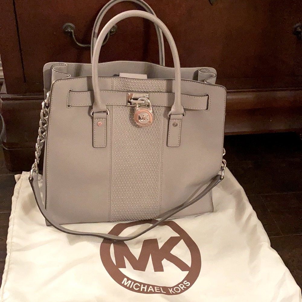 Michael Kors bag: new condition, gray leather, silver trim and dust cover,